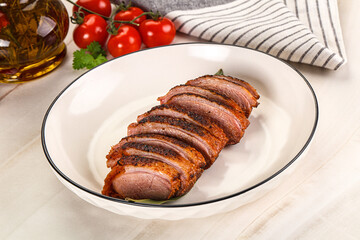 Sliced duck breast baked with cherry