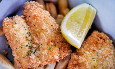 Classic Traditional English or British culinary delight Fish and Chips, golden deep fried fish with...