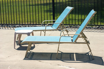 Retro pool chairs and table on deck