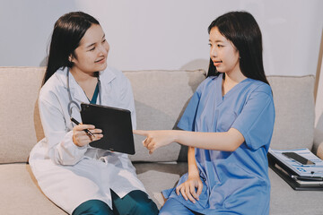A doctor uses a stethoscope to check the heartbeat of his patient. Patients must undergo a yearly...