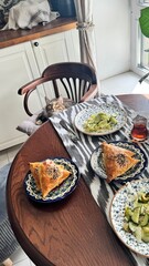 Cat tries to steal food from the table.Insolent assertive cat walks on the kitchen table. Stylish...