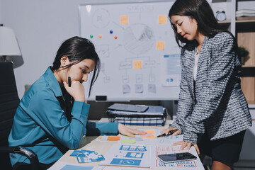 Group of young application developers analyzing uxui mobile app templates during a working meeting