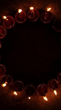 Vertical video of Indian festival Diwali, Closeup Festival Diya or Oil Lamp with Glowing Flame, diwali festive of light celebration background animation for social media story.