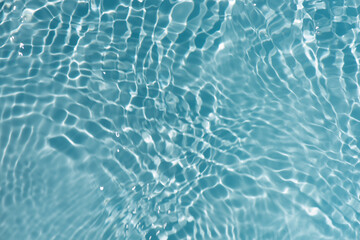 Blue water with ripples on the surface. Defocus blurred transparent blue colored clear calm water...