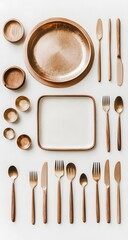 Top view of brass and wood plates and forks on a white flat lay. A big square dish holds space for copy or logos.

