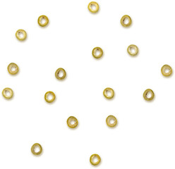A scattered arrangement of small, round, yellow objects resembling olives or decorative beads.