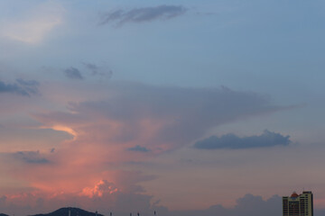 Serene Sunset Over Mountains With Colorful Clouds and Urban Skyline, Capturing the Tranquility of...