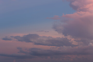 Serene Sunset Sky with Gentle Clouds in Soft Pastels of Pink, Blue, and Purple, Ideal for Backgrounds, Nature, and Tranquil Scenes in Photography and Design