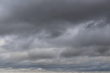 Majestic Overcast Sky with Dramatic Gray Clouds and Soft Light Illuminating Bottom Layer of...