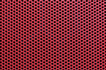 Close-Up of a Vibrant Red Perforated Metal Surface Featuring Uniform Round Holes and a Distinctive...