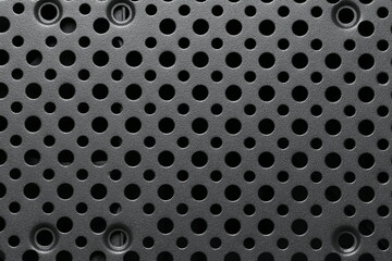 Close-Up View of a Textured Black Surface with Multiple Circular Holes for Abstract Backgrounds,...