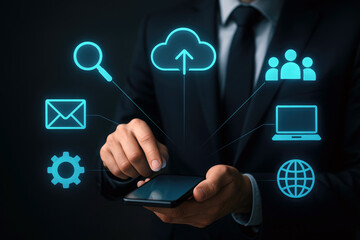 Businessman using smartphone interacts with digital interface showing cloud upload email search group laptop globe and settings icons glowing cyan blue on dark background