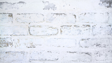The texture of old white brickwork. A gray brick wall with plaster and whitewash.