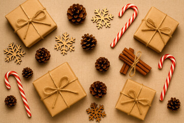 Fototapeta premium Kraft Paper Wrapped Christmas Gifts Pine Cones Wooden Snowflakes Cinnamon Sticks Candy Canes Tan Background