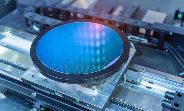 Semiconductor and Computer Chip Manufacturing at Fab or Foundry with robotic arms with silicon wafers
