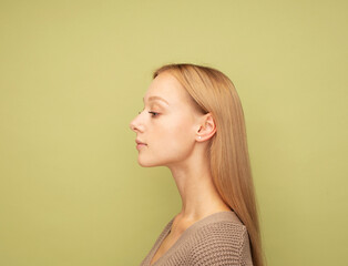 Pretty blond woman wearing brown sweater with cute smile.