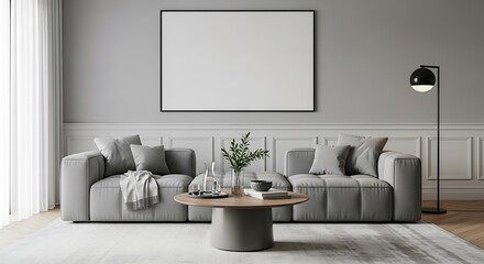 Modern living room with grey sofas a round coffee table and a blank canvas on the wall