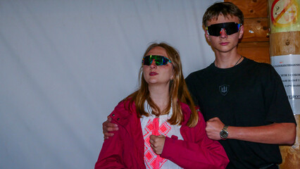 young guy and blonde girl in black glasses, portrait, satisfied, smiling, fashion, close-up,...