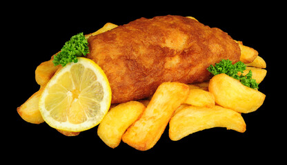 Beer battered cod fish fillet with chunky chips and lemon and parsley garnish on a black background