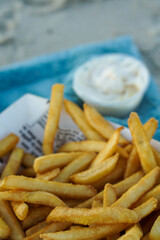 french fries in paper at the beach