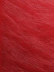 Fototapeta premium Close-up of deep red textured surface resembling leather or vinyl; subtle diagonal grain pattern