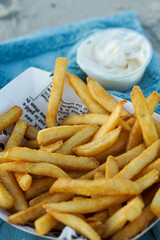 fries in newspaper at the beach