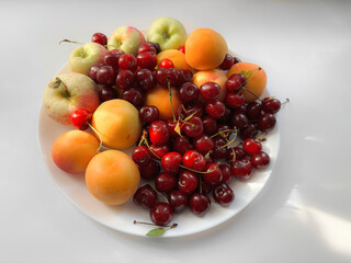 A plate of fruits in the sun