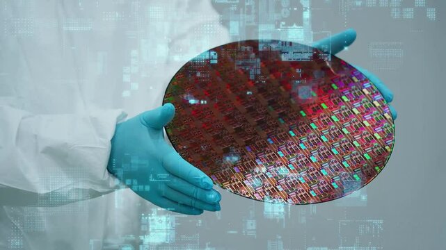Digital technology concept with worker holding semiconductor wafer