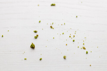 Closeup of fresh baked matcha cookies crumble on white wooden background.