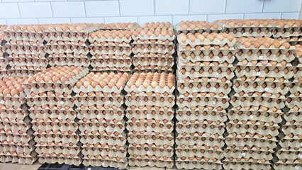 Packed Egg Cartons: Rows of fresh eggs meticulously arranged within their cardboard homes, create a stunning pattern. A testament to farm-fresh quality and food preparation.