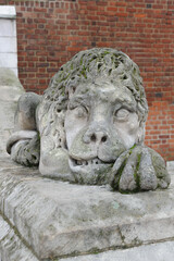 Old weathered sculpture of lion in front of City Hall at main square in Krakow, Poland