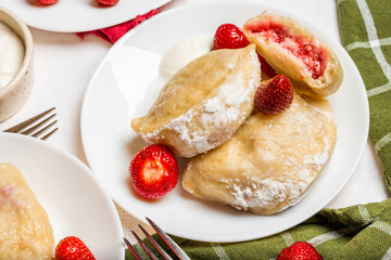 Freshly cooked strawberry dumplings cut open to reveal juicy filling. A great asset for food blogs,...