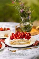 Beautiful crepe layer cake with strawberries and cream. Al fresco dessert in warm, natural light.