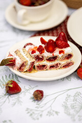 Cozy garden moment with crepe cake, strawberries, and wildflowers. Rustic summer mood.