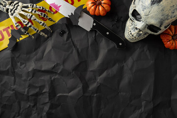Spooky arrangement of seasonal decorations for Halloween, featuring a skeleton, pumpkins, and...