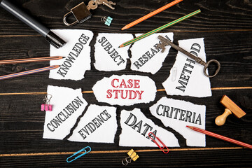 Case Study Concept with Torn Paper Pieces Showing Keywords on Dark Wooden Background