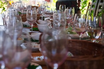 Wooden table after party with dirty dishes and wasted food