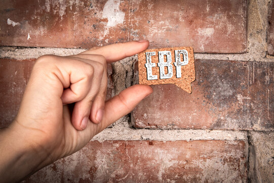 EBP Evidence based practice concept. Text in Speech Bubble Held by Hand on Brick Wall Background