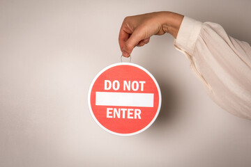Blank Do Not Enter Sign Concept Held by Hand on Neutral Background
