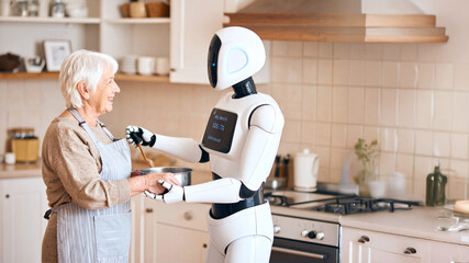 A smiling elderly woman and a white robot collaboratively cook in a bright kitchen, showcasing AI's role in assisting seniors and modern home life.