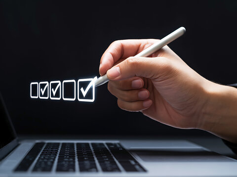 Two hands using digital pen to mark holographic checkboxes on a laptop screen
