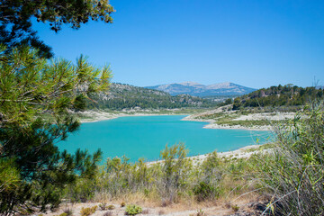 Apolakkia dam lake in Rhodes in Greece. Beautiful blue color Apolakkia Reservoir lake between mountains and forest.
