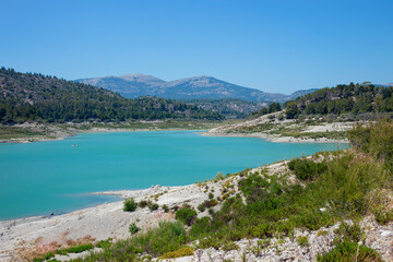 Apolakkia dam lake in Rhodes in Greece. Beautiful blue color Apolakkia Reservoir lake between mountains and forest.