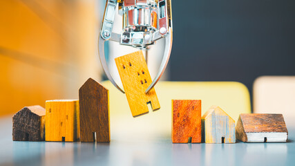 A robot lifting a house model, among others on a table, illustrates AI-powered real estate selection for optimized profit and minimized risk.