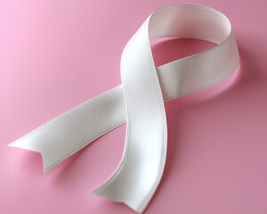 Elegant white ribbon on a soft pink background symbolizing hope and awareness