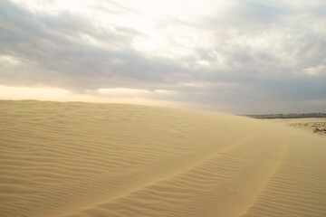 Golden Sand Under a Cloudy Sky A Serene Desert Landscape Experience. Mui Ne, Vietnam, White Dunes.