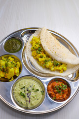 Crispy Masala dosa is a popular South Indian food item served with tomato chutney, coconut chutney, spicy potato masala, or aloo ki sabzi and sambar. Copy space. Crunchy Rice crepes.