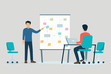 Man presenting a flowchart on a whiteboard to a colleague working on a laptop