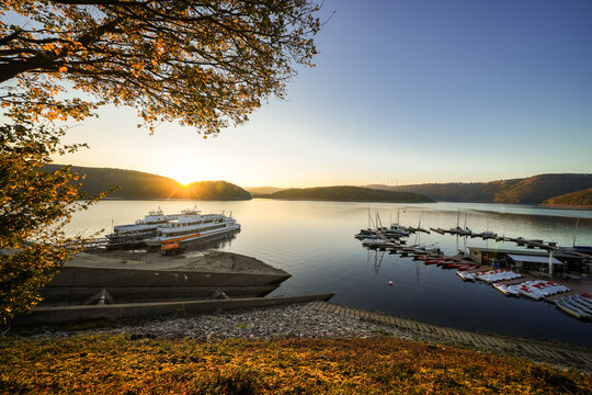 View of the Rursee at the dam near Heimbach-Schwammenauel. Landscape at the lake at sunset. Nature in the Eifel National Park.
