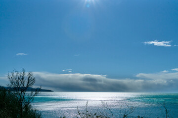 Tranquil Coastal View With Sparkling Sea Under a Clear Blue Sky